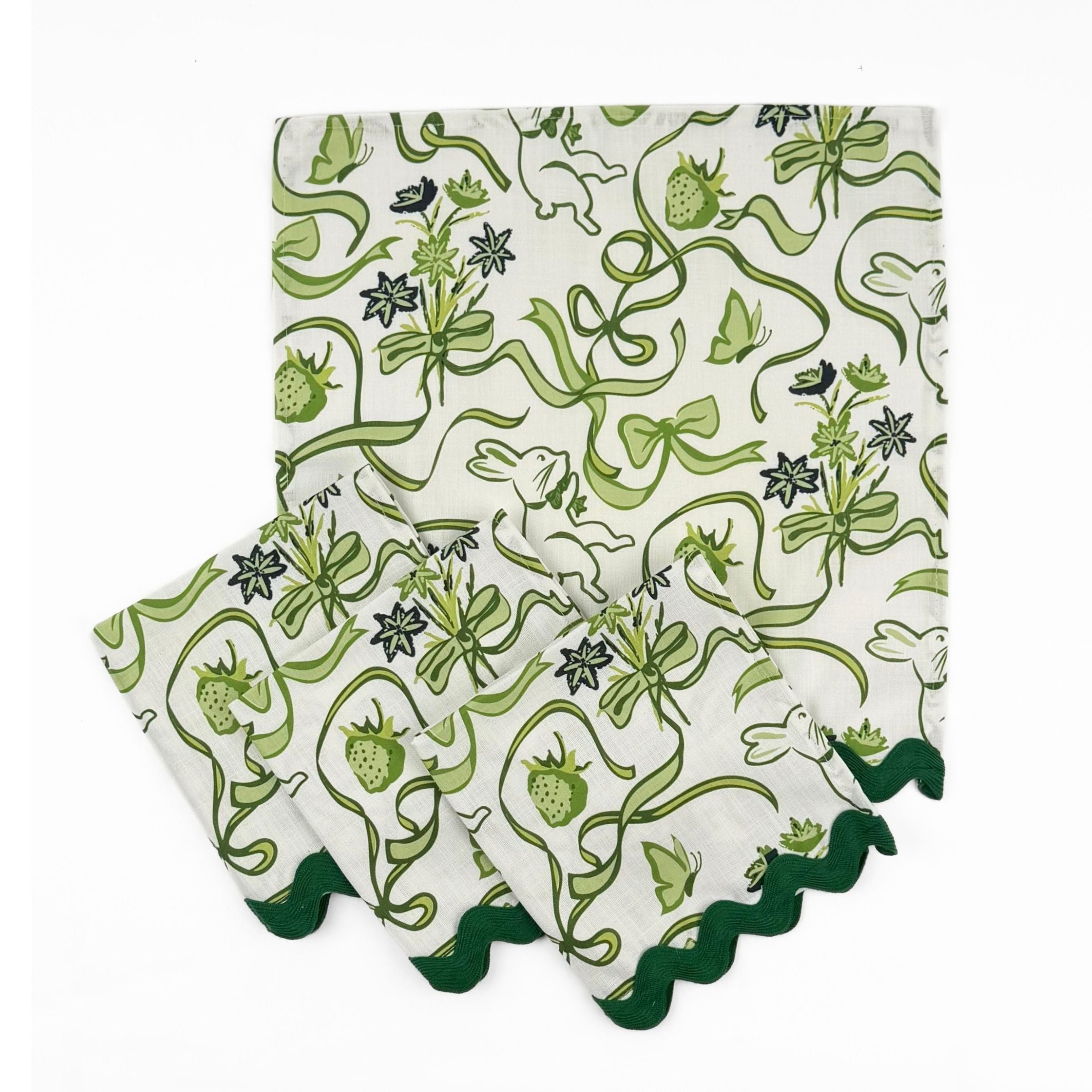 Set of White dinner napkins featuring green bunnies, bows, strawberries, floral patterns, and dark green ric rac trim.