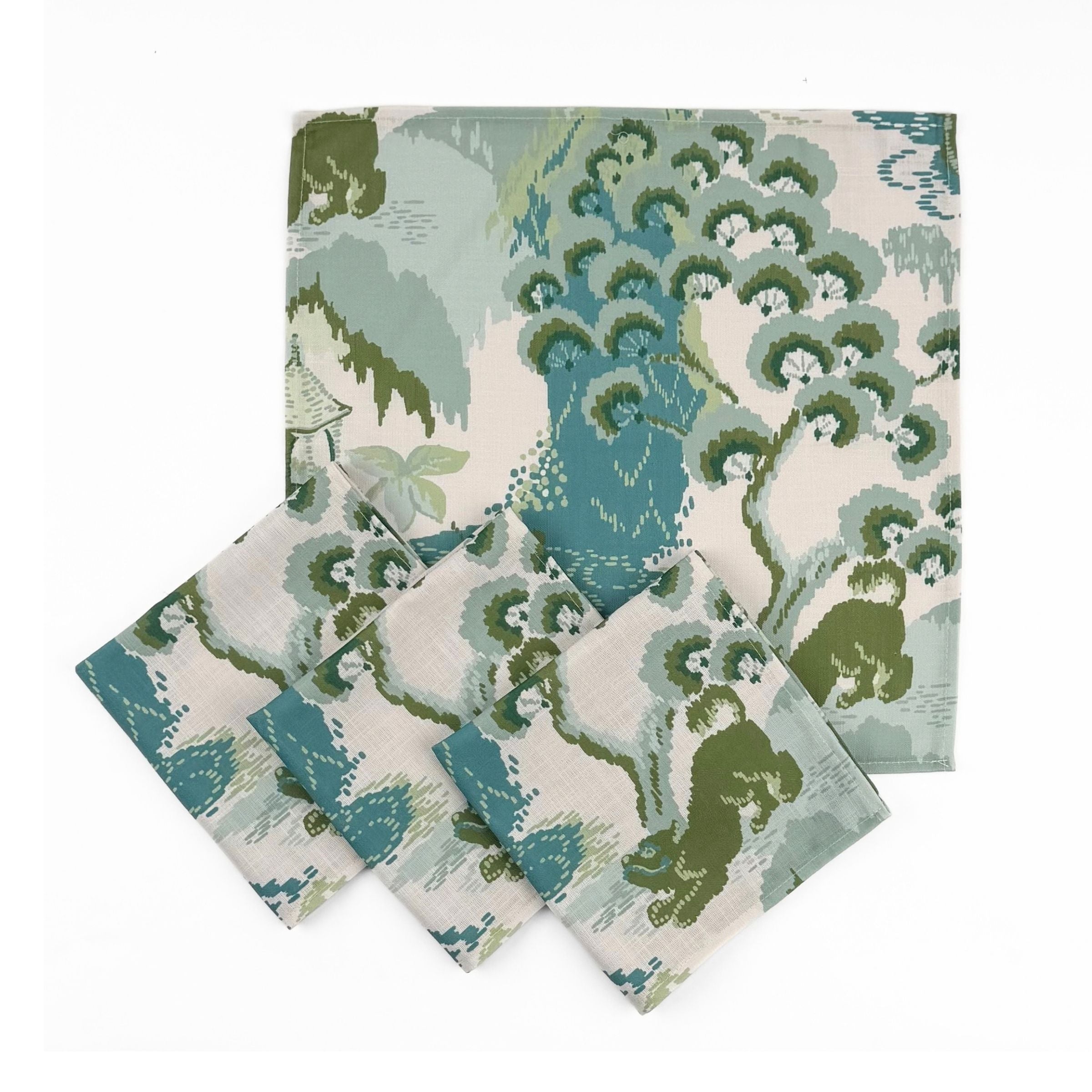 Set of Elegant cloth dinner napkins featuring traditional chinoiserie landscapes in soft green, blue, and ivory tones.