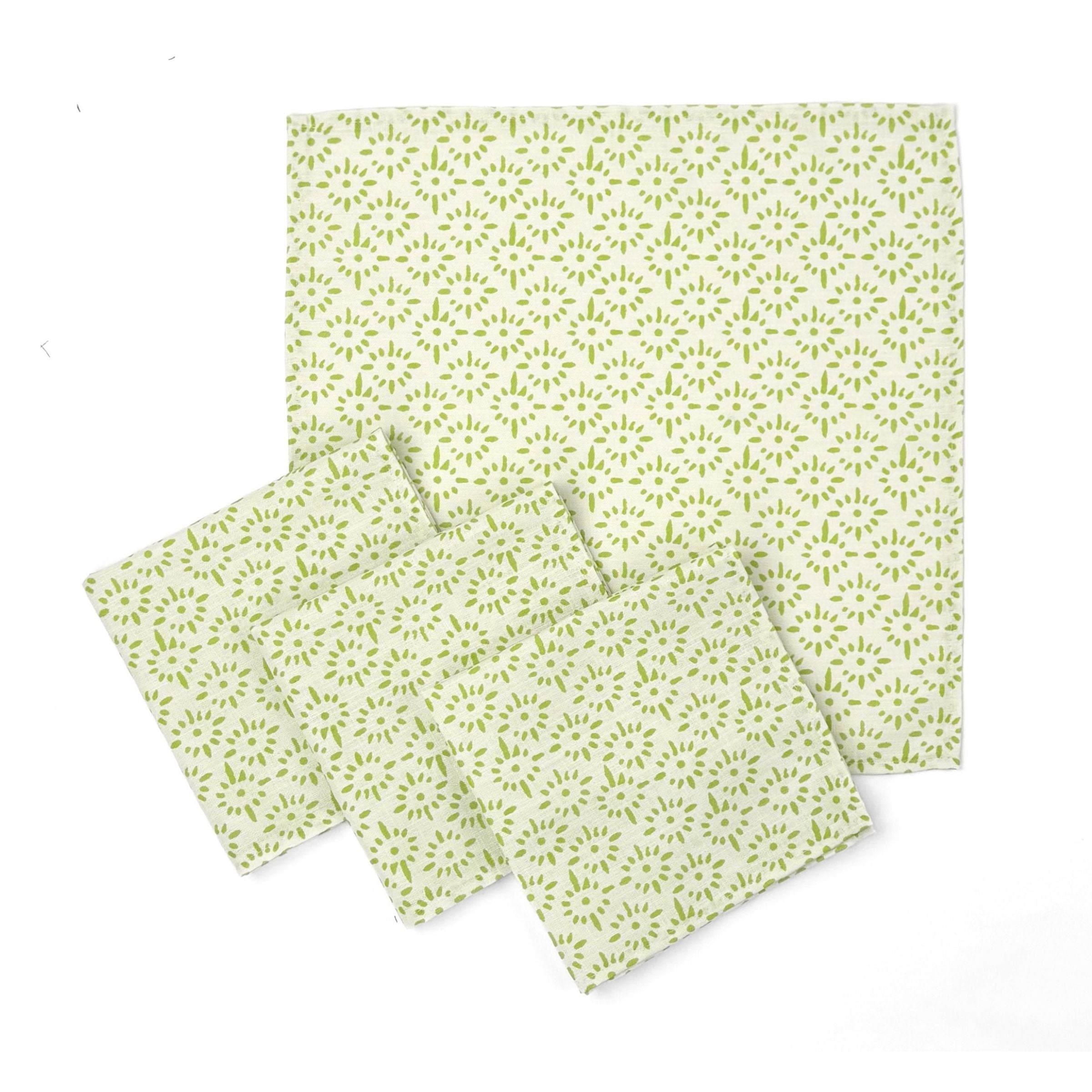 Set of White cloth dinner napkins featuring delicate green block print floral patterns for charming everyday tablescapes.