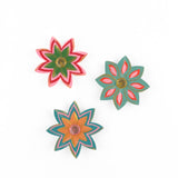 Colorful jeweled flower Christmas ornaments featuring hand-painted floral designs, vibrant petals, and sparkling gemstone centers.