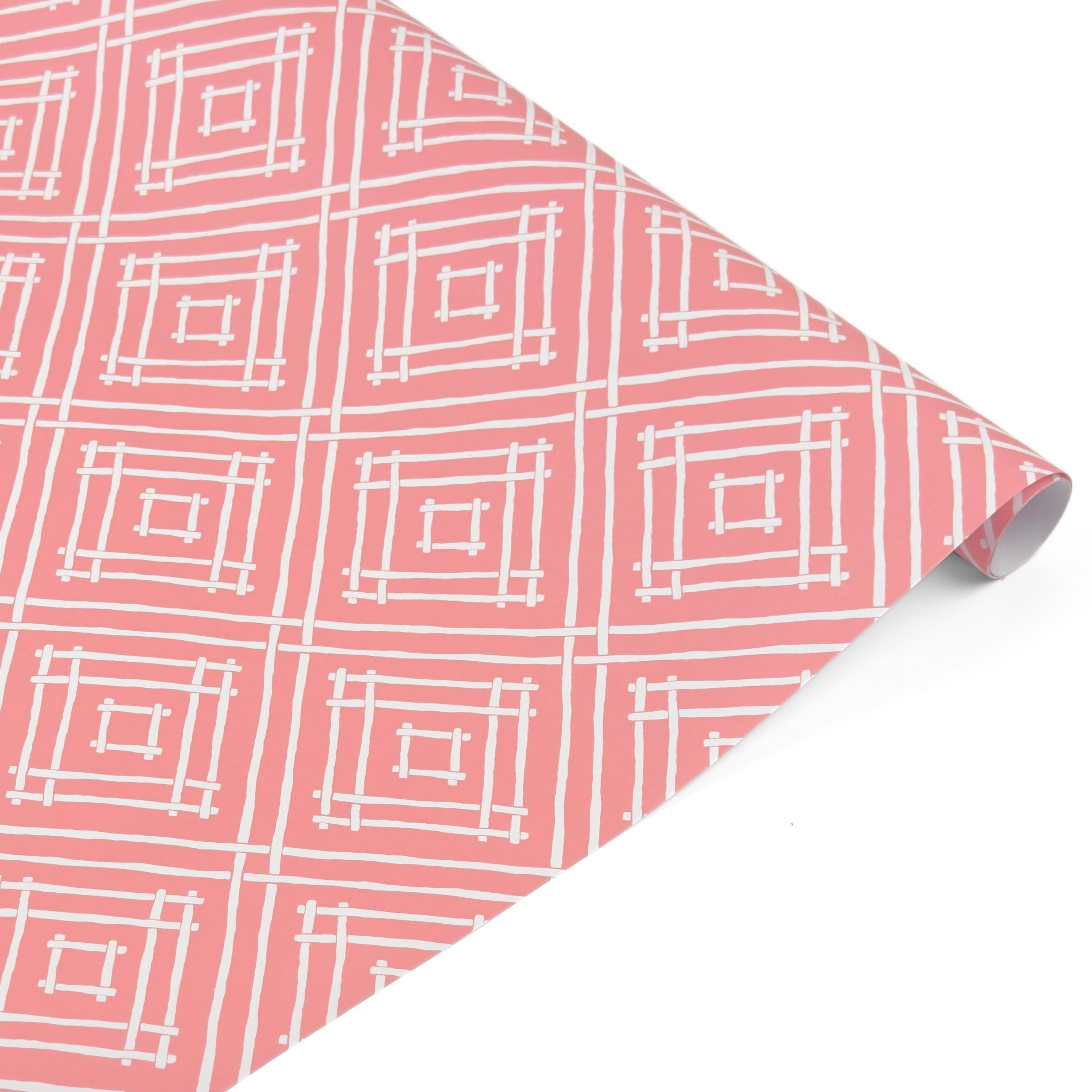 a roll of wrapping paper with a geometric lattice pattern in pink
