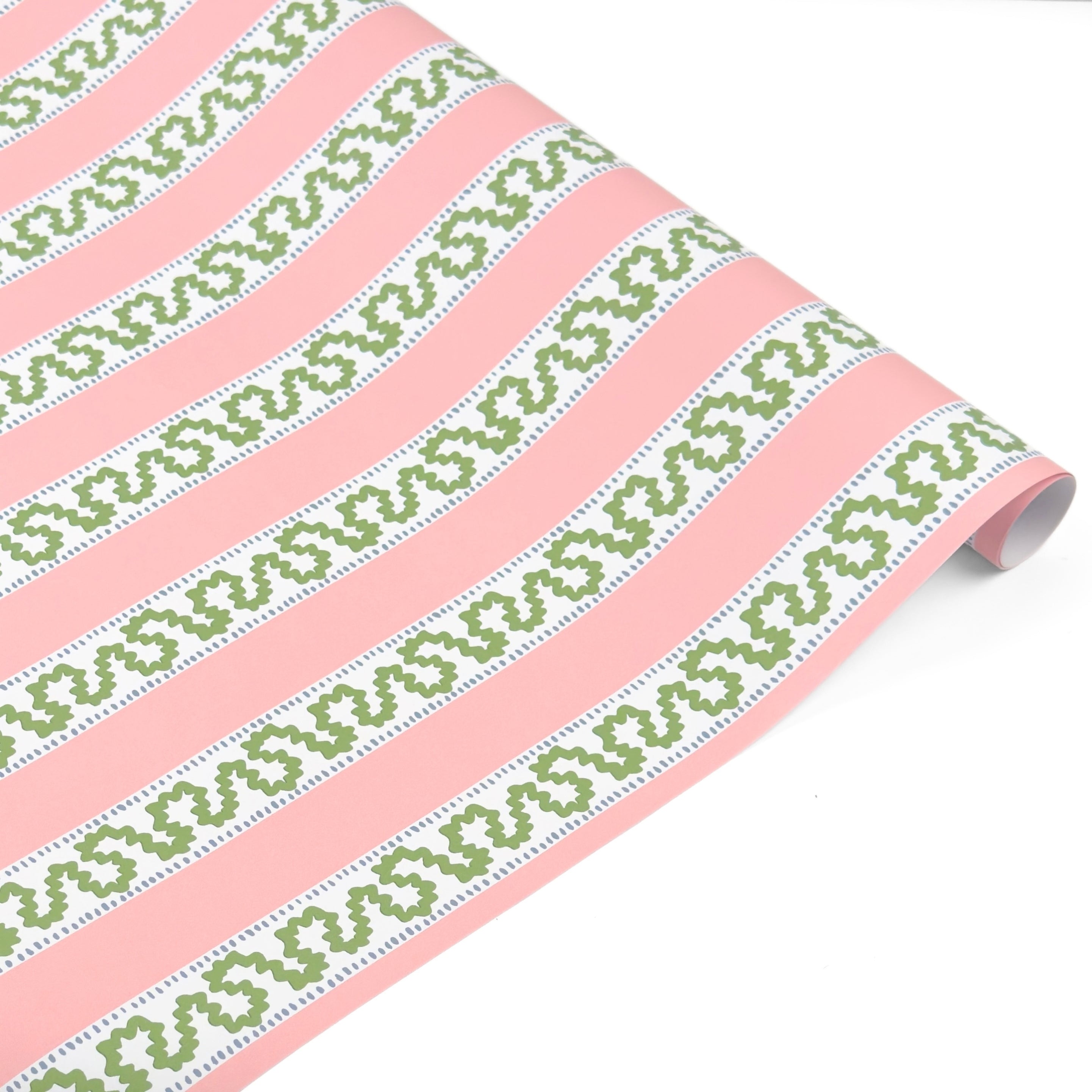Pink and green striped Christmas wrapping paper roll with decorative pattern.