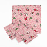 Set of Pink Christmas dinner napkins featuring swirling ribbons, nutcrackers, ballerinas, festive gifts, and whimsical holiday illustrations.