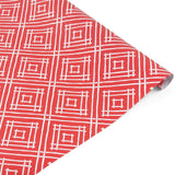 Rolled red gift wrap featuring white geometric square pattern.
