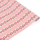 a roll of red and pink striped wrapping paper in fancy stripe patterns