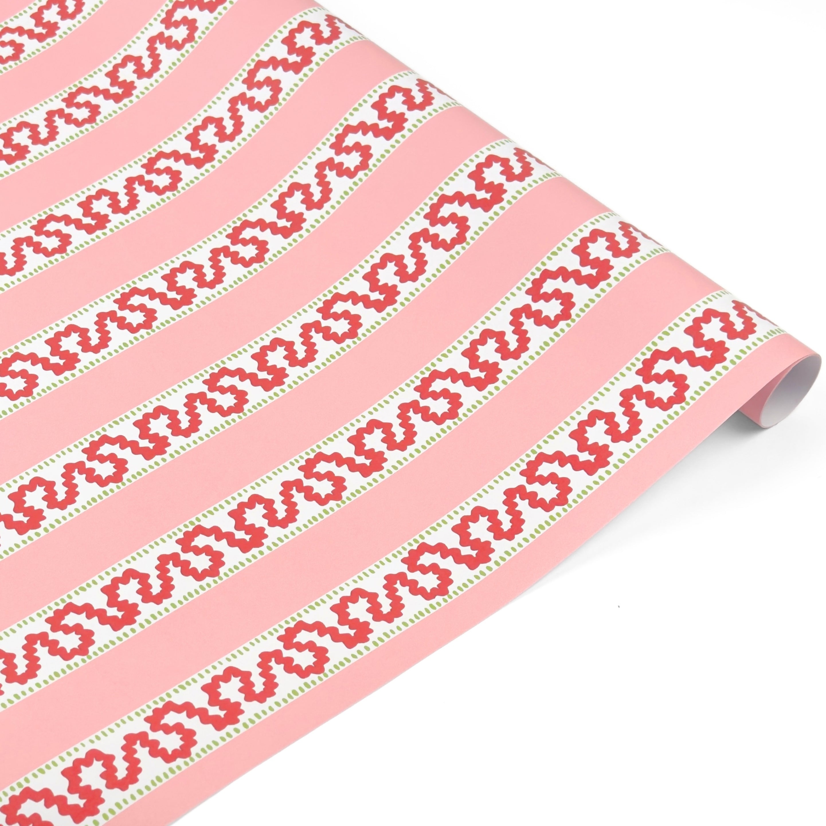 a roll of red and pink striped wrapping paper in fancy stripe patterns