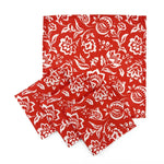 Set of Red cloth dinner napkins featuring intricate white block print floral patterns for elegant table settings.