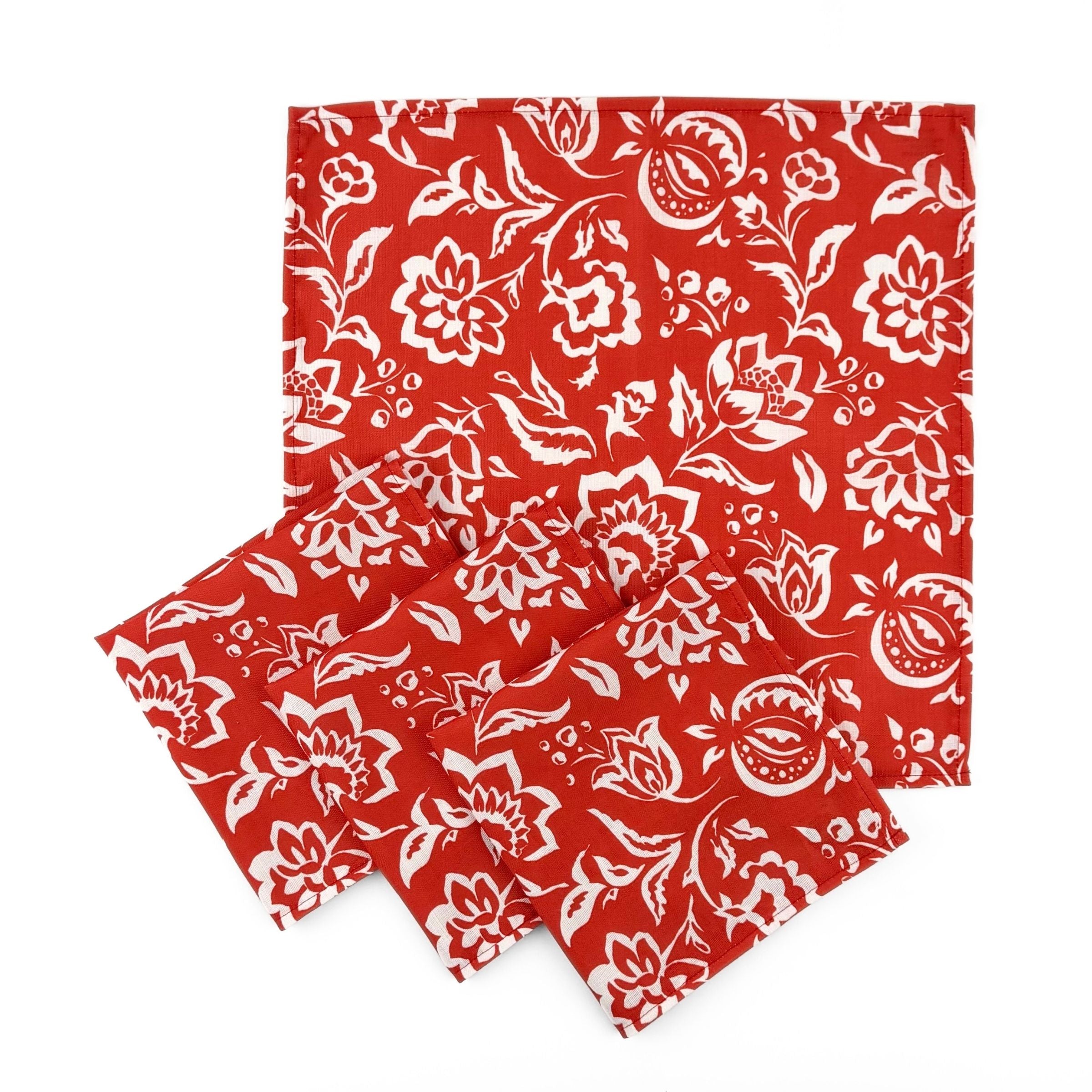 Set of Red cloth dinner napkins featuring intricate white block print floral patterns for elegant table settings.
