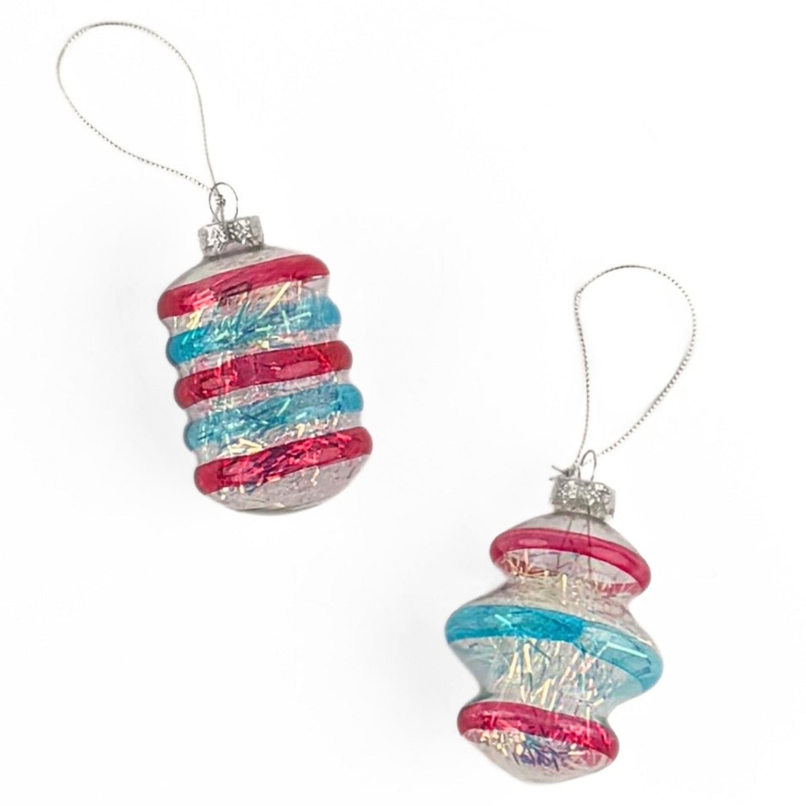 Patriotic tinsel glass ornaments featuring shimmering red, blue, and silver stripes with festive metallic finishes.