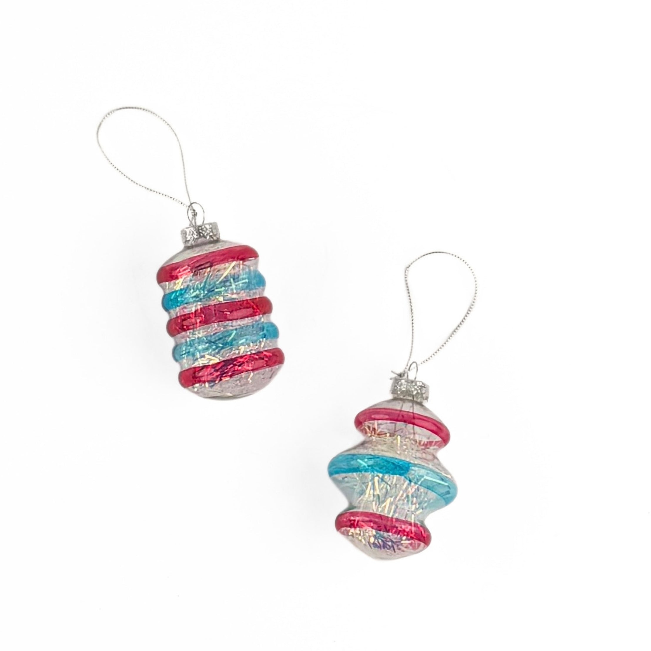 Patriotic tinsel glass ornaments featuring shimmering red, blue, and silver stripes with festive metallic finishes.
