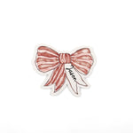 Elegant red bow place cards featuring delicate white stripes and personalized names for festive table settings.