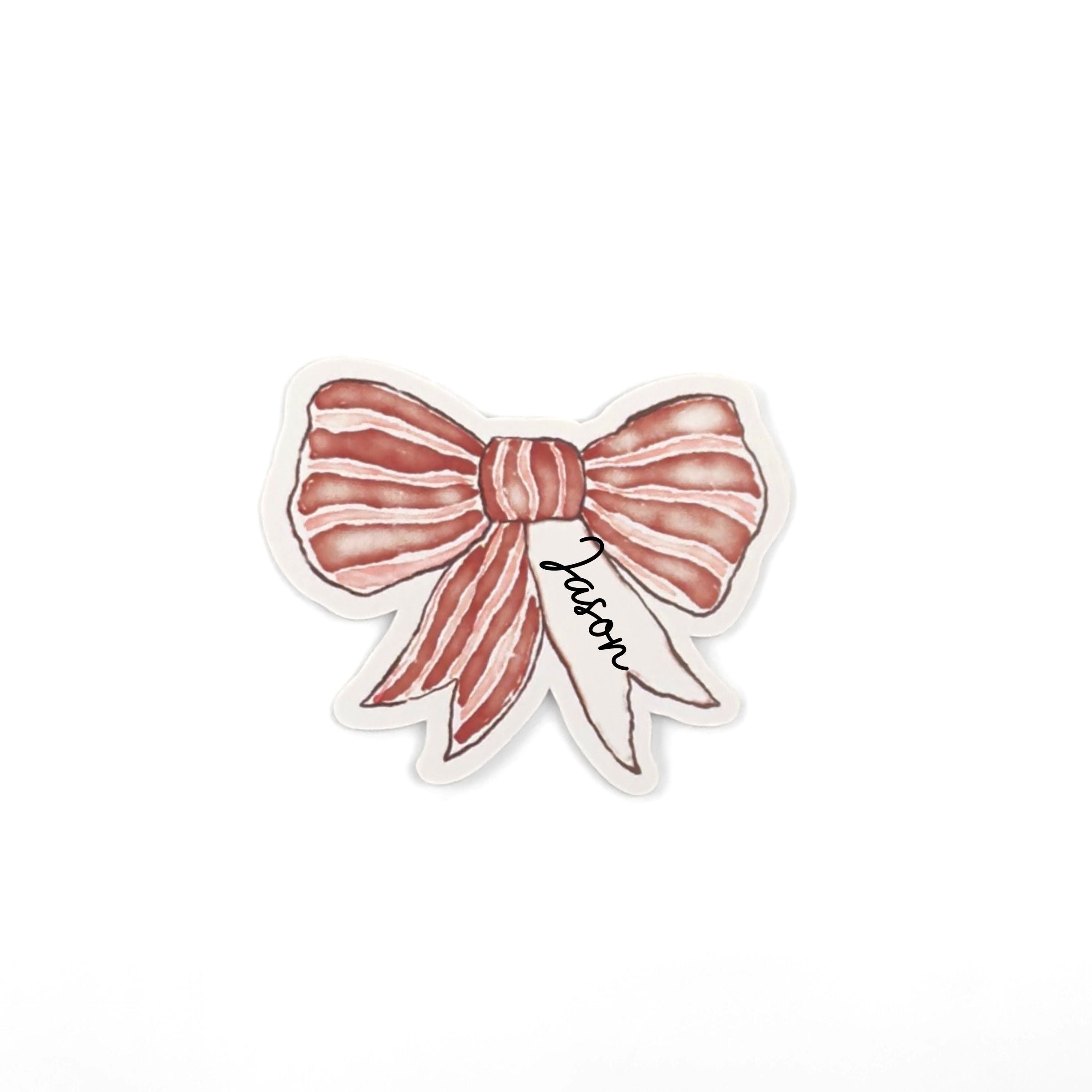 Elegant red bow place cards featuring delicate white stripes and personalized names for festive table settings.