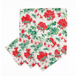 Set of White cloth dinner napkins featuring vibrant red geranium flowers and lush green leaves for tablescapes.
