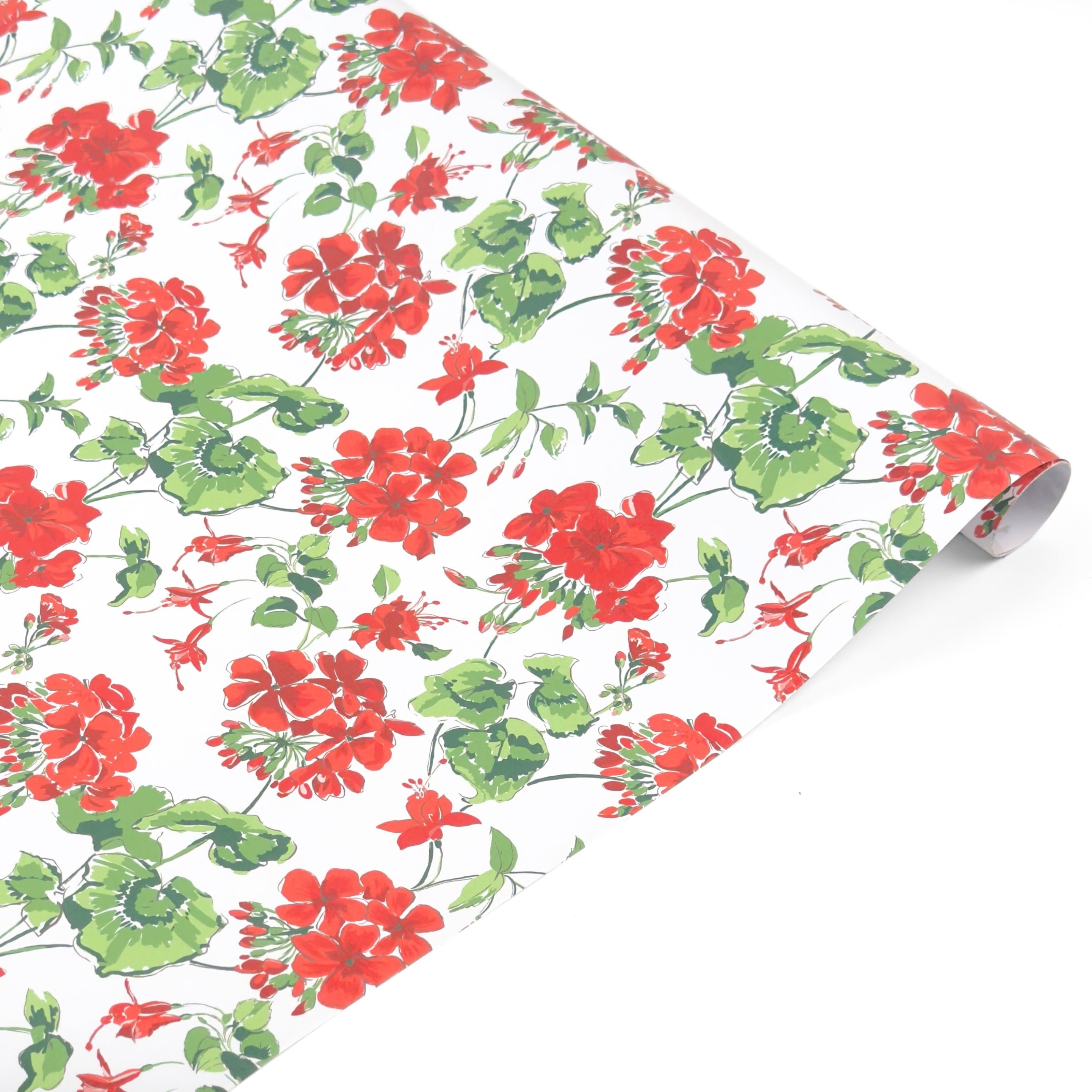 Roll of red geranium floral wrapping paper on a white background.