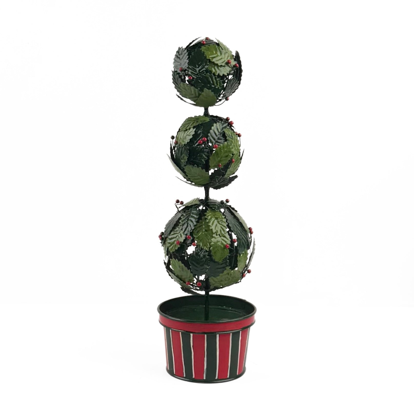 A tole metal three tiered holly topiary ball centerpiece with a striped red and green pot forming the base. 