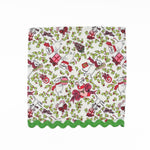 White Christmas dinner napkins featuring festive mice, holly leaves, colorful gifts, and green scalloped trim.