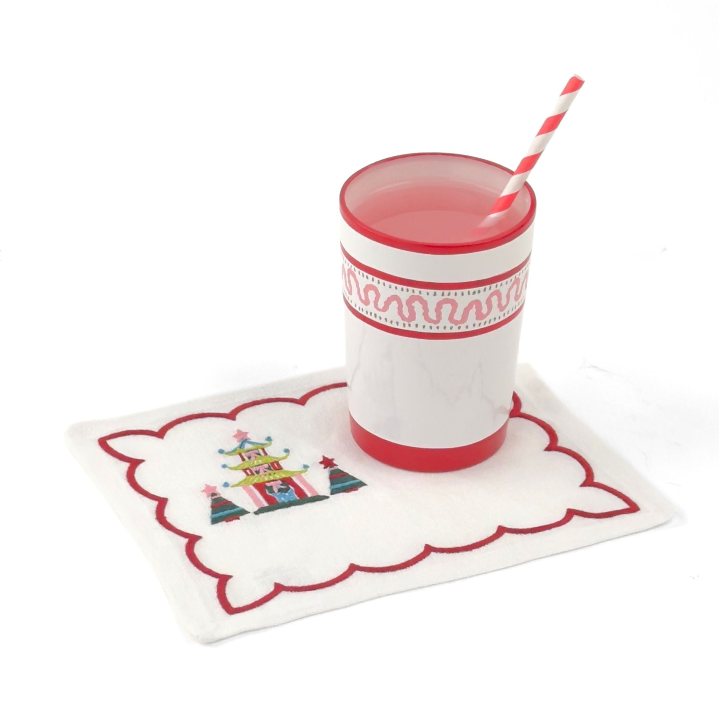 Elegant white cocktail napkins featuring red scalloped borders, colorful Christmas pagodas, festive trees, and embroidery.