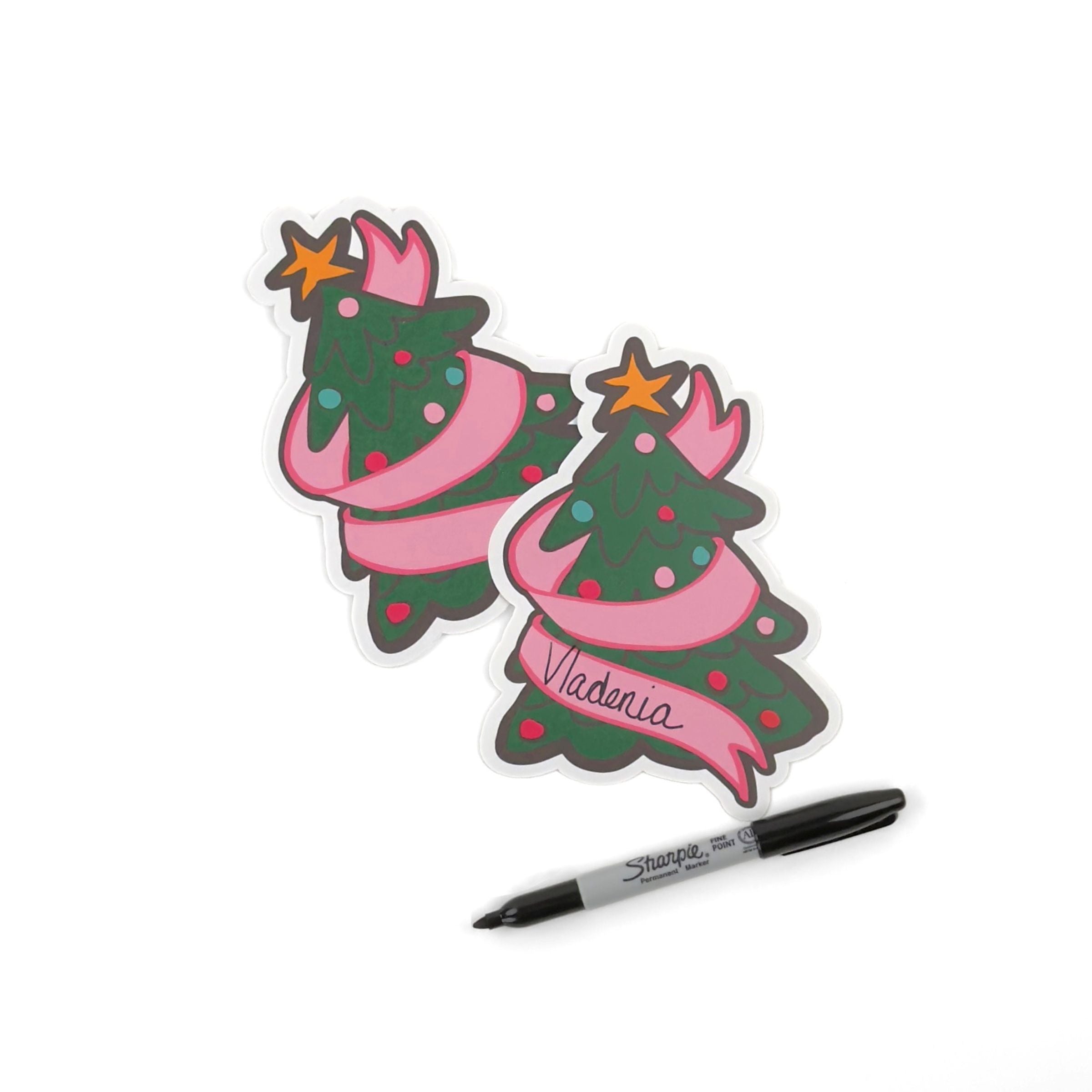 Two Festive Christmas tree place card featuring colorful ornaments, a pink ribbon, and space for personalized names.