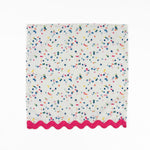 White cloth dinner napkins featuring playful multicolor confetti dots and bright pink ric rac trim.