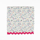 White cloth dinner napkins featuring playful multicolor confetti dots and bright pink ric rac trim.