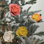 Four Charming felt flower ornaments featuring colorful layered petals, green leaves, delicate embroidery, and sparkling sequin accents.