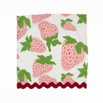 White cloth dinner napkins featuring pink strawberries, green leaves, and red scalloped trim for tablescapes.