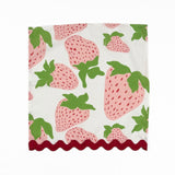 White cloth dinner napkins featuring pink strawberries, green leaves, and red scalloped trim for tablescapes.