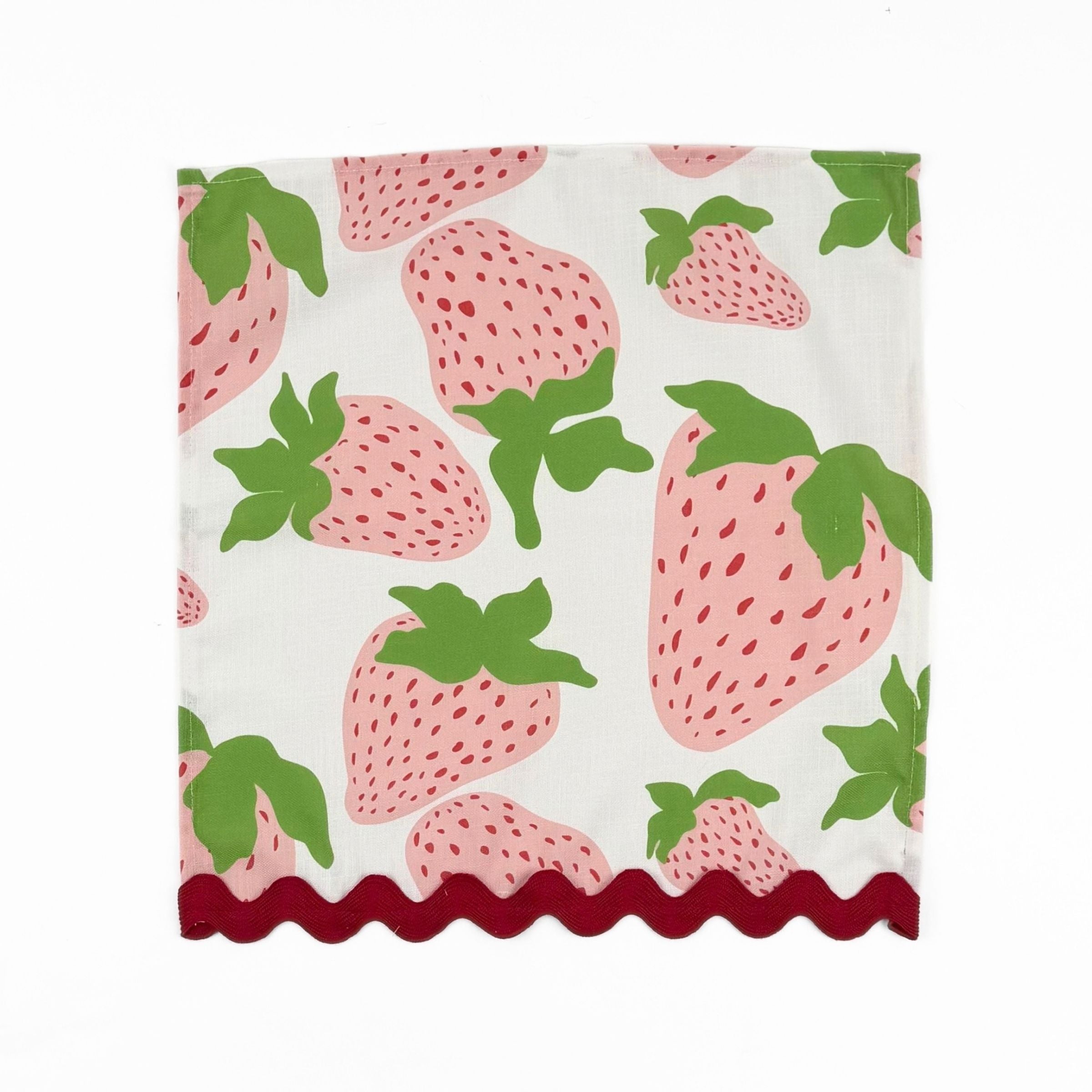 White cloth dinner napkins featuring pink strawberries, green leaves, and red scalloped trim for tablescapes.
