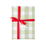 Green gingham gift wrap styled with red ribbon and holiday gift tag.