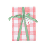 Gift wrapped in pink and white gingham paper with green ribbon and Christmas gift tag.