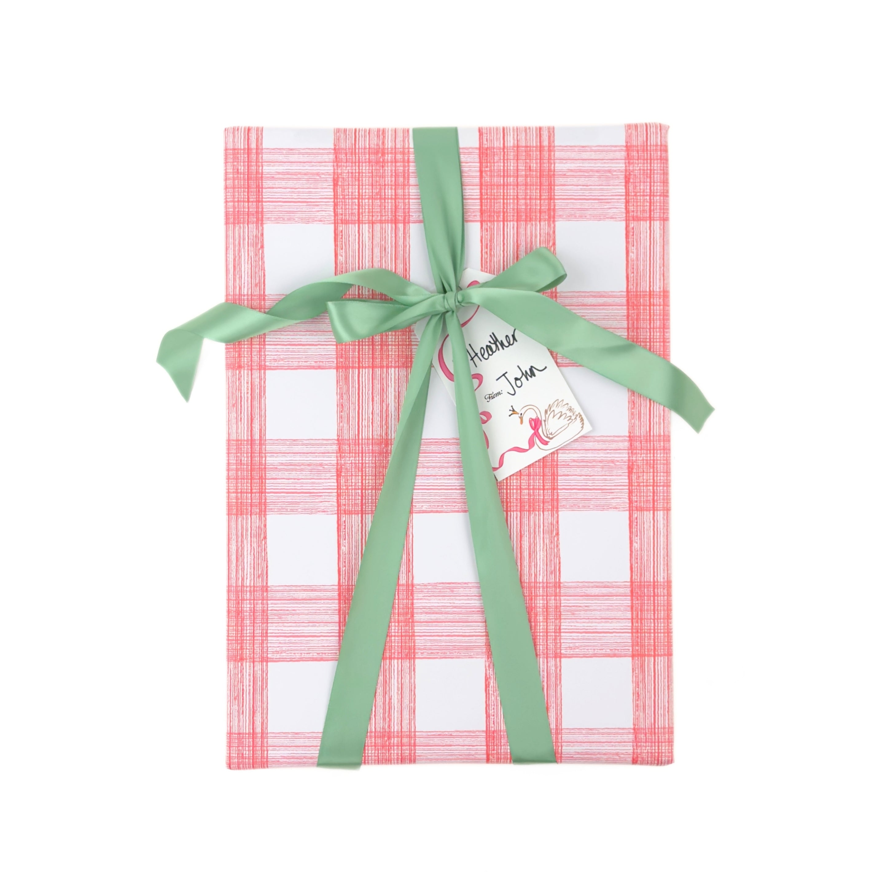 Gift wrapped in pink and white gingham paper with green ribbon and Christmas gift tag.