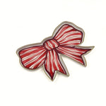 Red and white striped bow-shaped tray with gold edging displayed on a white background.
