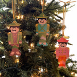 Festive hand-painted wooden nutcracker Christmas ornaments featuring colorful soldier designs and gold hanging cords for decorating.