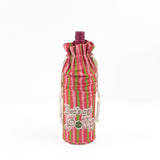 pink and green striped wine bag with “Let’s get jolly!” printed on the front