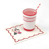 Elegant white cocktail napkins featuring red scalloped borders, colorful Christmas ornaments, holly, and festive embroidery.