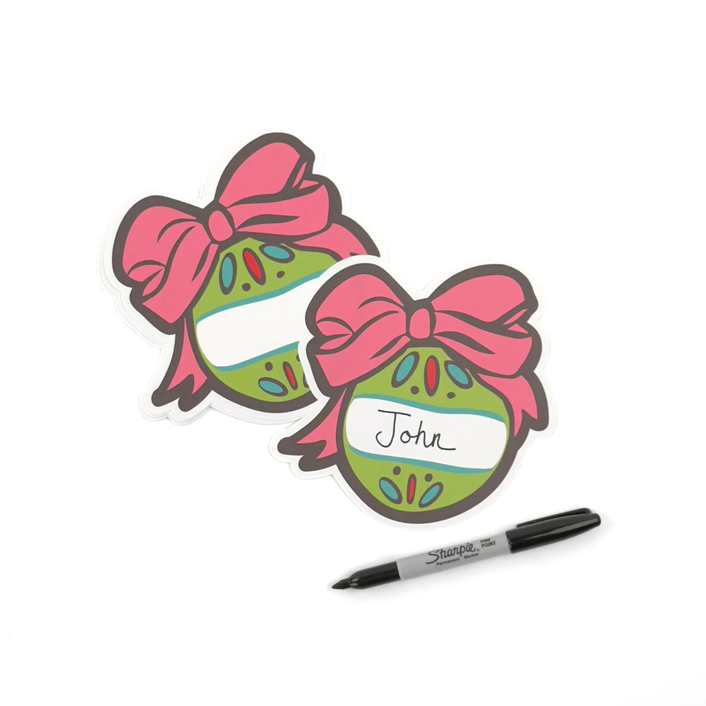 Festive ornament place card featuring a green Christmas bauble, pink bow, and personalized name space.