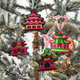 four pink felt chinoiserie christmas ornaments in the shape of pagodas against a white background 