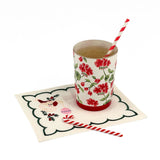 Elegant white cocktail napkins featuring green scalloped borders, embroidered Santa faces, holly, and pink ornaments.