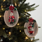 Festive glass Christmas ornaments featuring Santa and snowman designs with sparkling silver, red, and green accents.