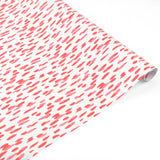 a roll of gift wrap with a pink brushstroke pattern design. 