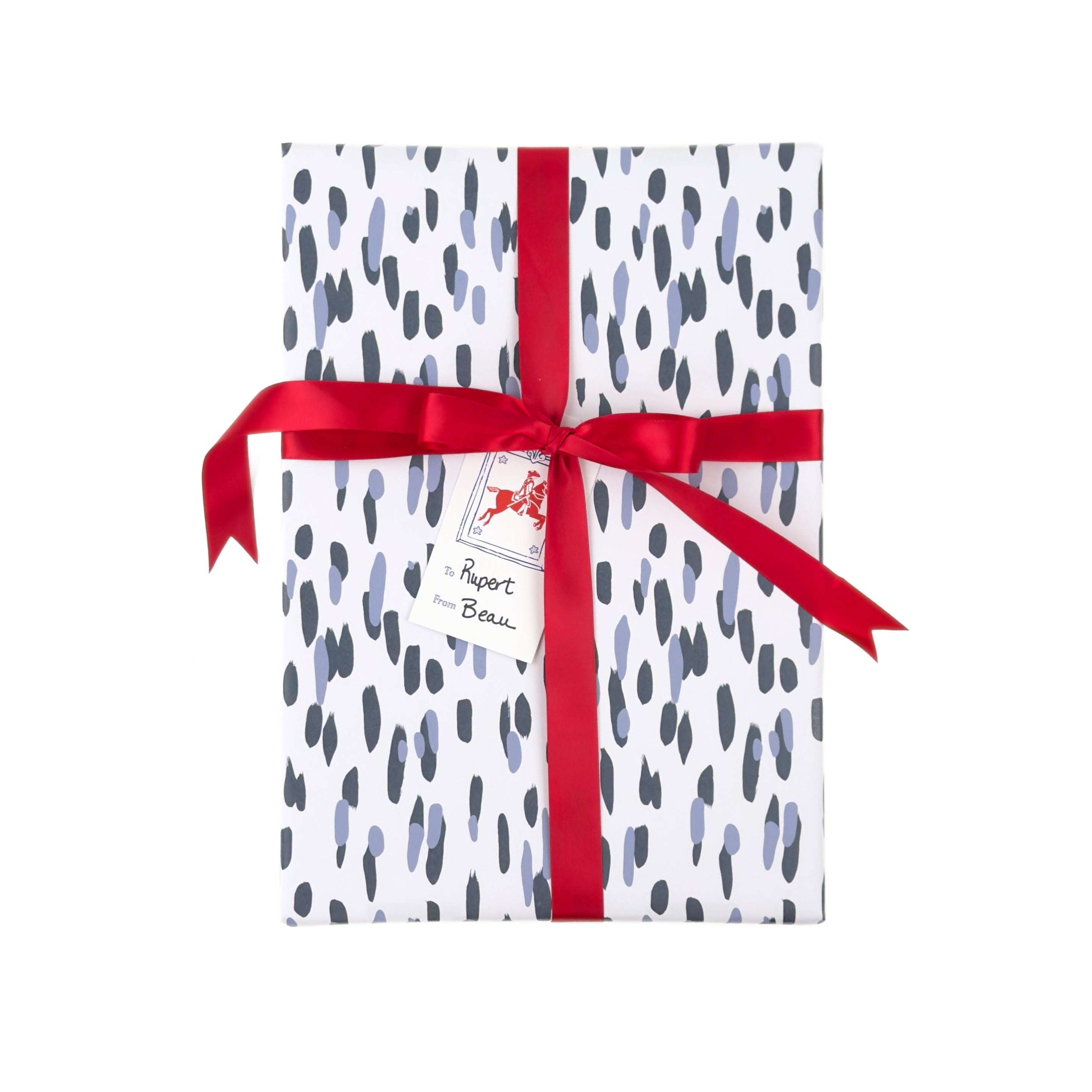 Gift wrapped in blue brushstroke wrapping paper with red ribbon and blue patriotic tag.