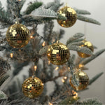 Six Gold mini disco ball ornaments featuring shimmering mirrored tiles, perfect for festive Christmas tree decorating.
