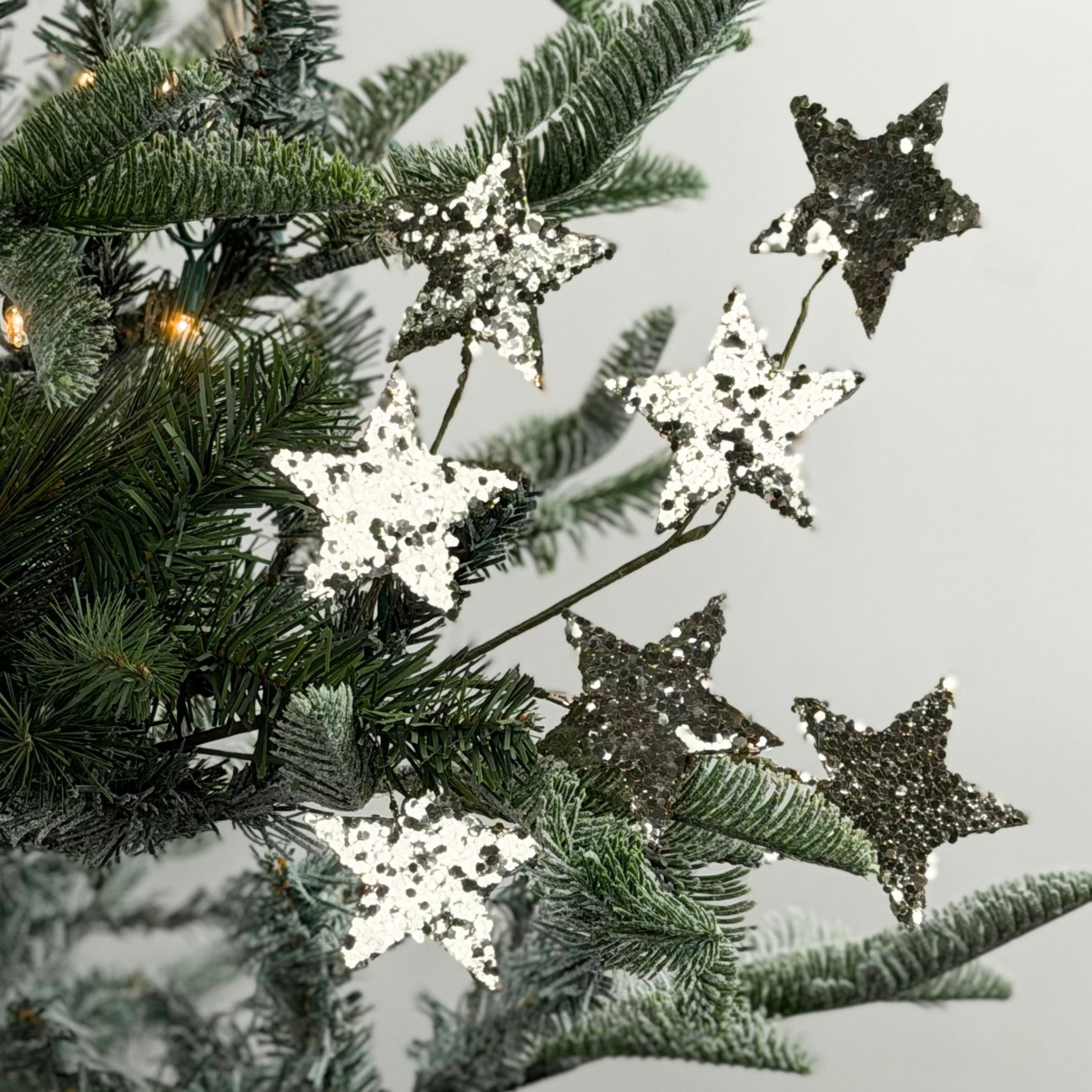 Gold champagne spray of stars featuring sparkling glitter accents, perfect for festive Christmas trees and arrangements.
