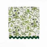 White dinner napkins featuring green bunnies, bows, strawberries, floral patterns, and dark green ric rac trim.