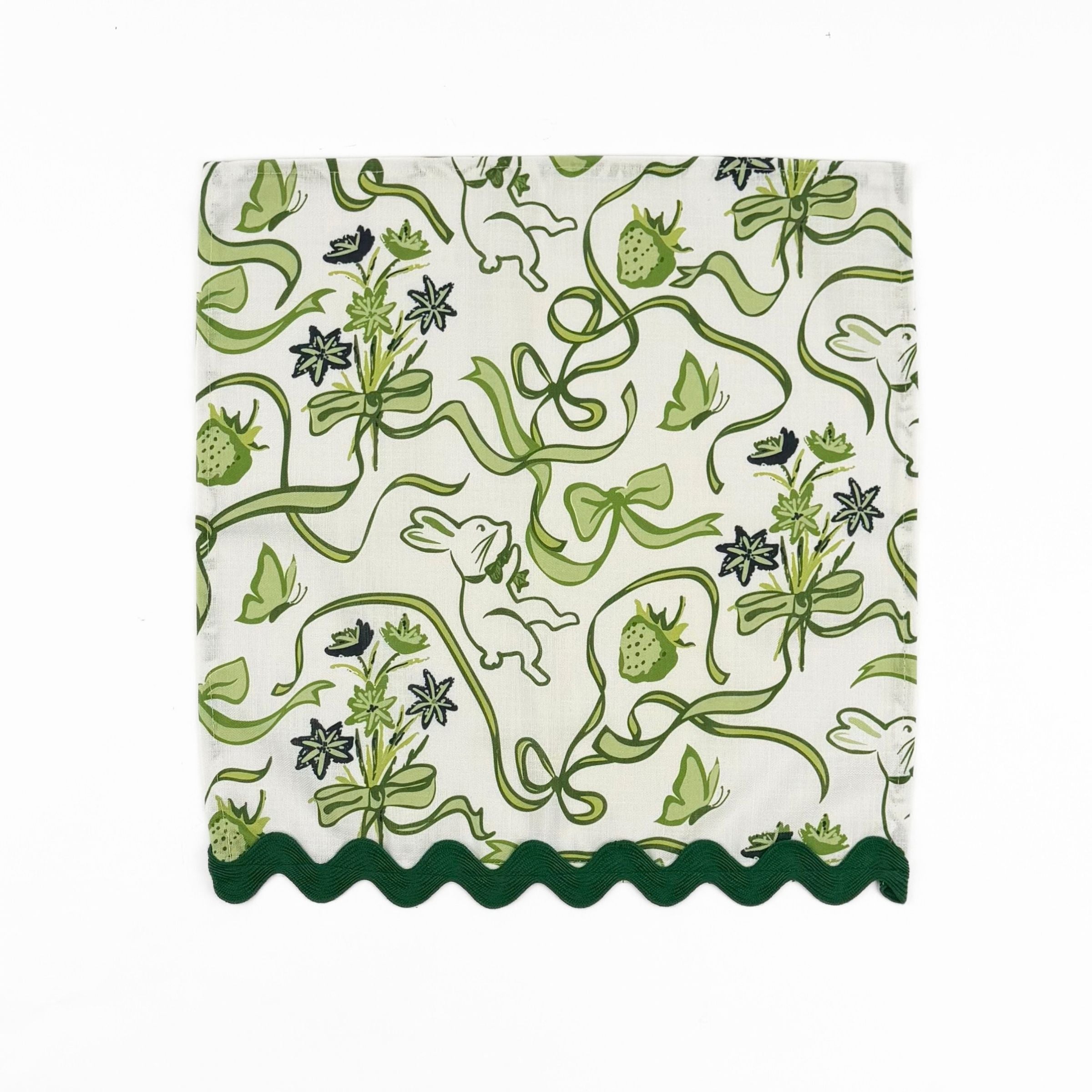 White dinner napkins featuring green bunnies, bows, strawberries, floral patterns, and dark green ric rac trim.