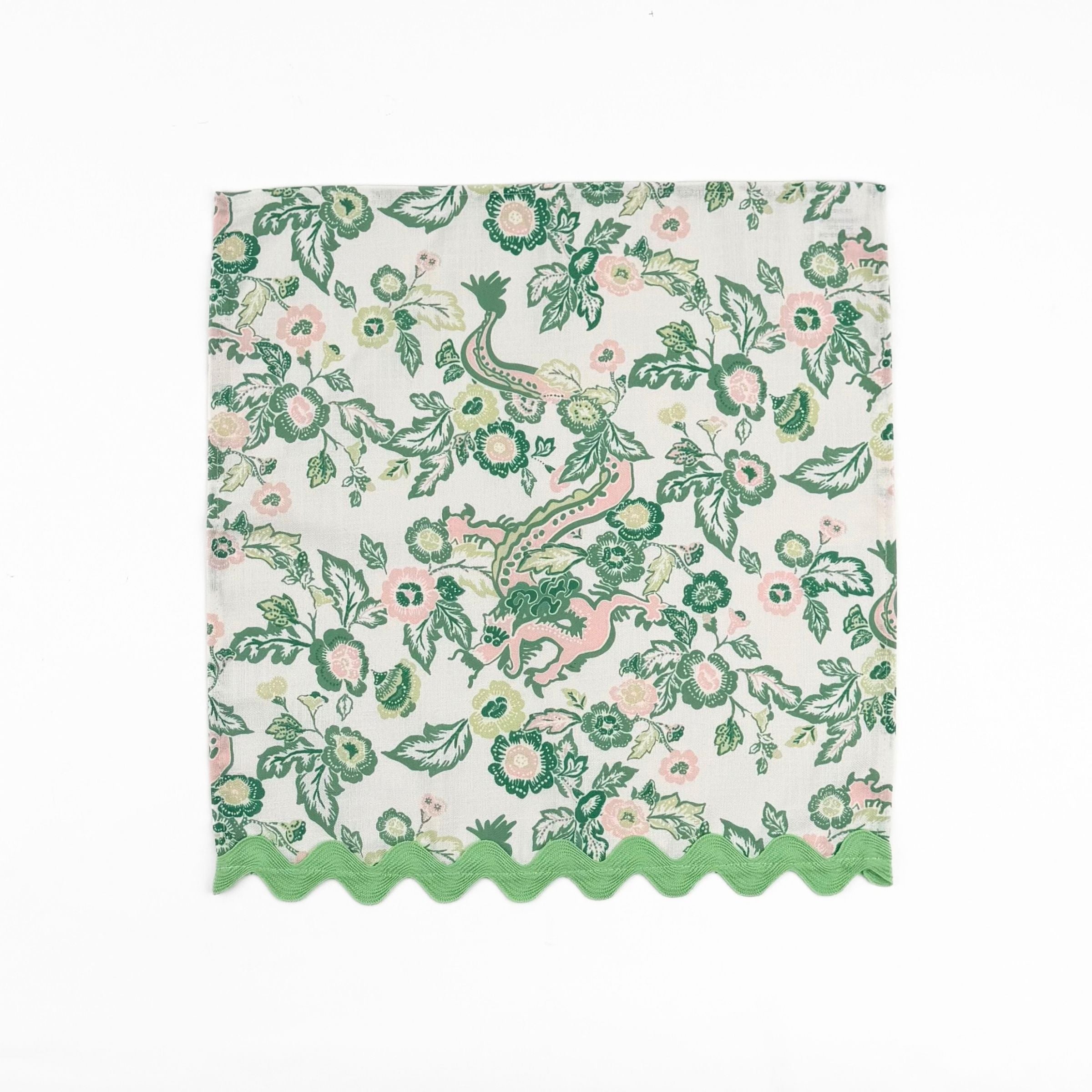 Cloth dinner napkins featuring green Chinese dragon and pink floral prints with green ric rac trim.