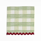 Green and white gingham cloth dinner napkins featuring red scalloped trim for charming holiday tablescapes.