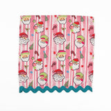 Pink striped Christmas dinner napkins featuring cheerful Santa faces, festive motifs, and turquoise ric rac trim.