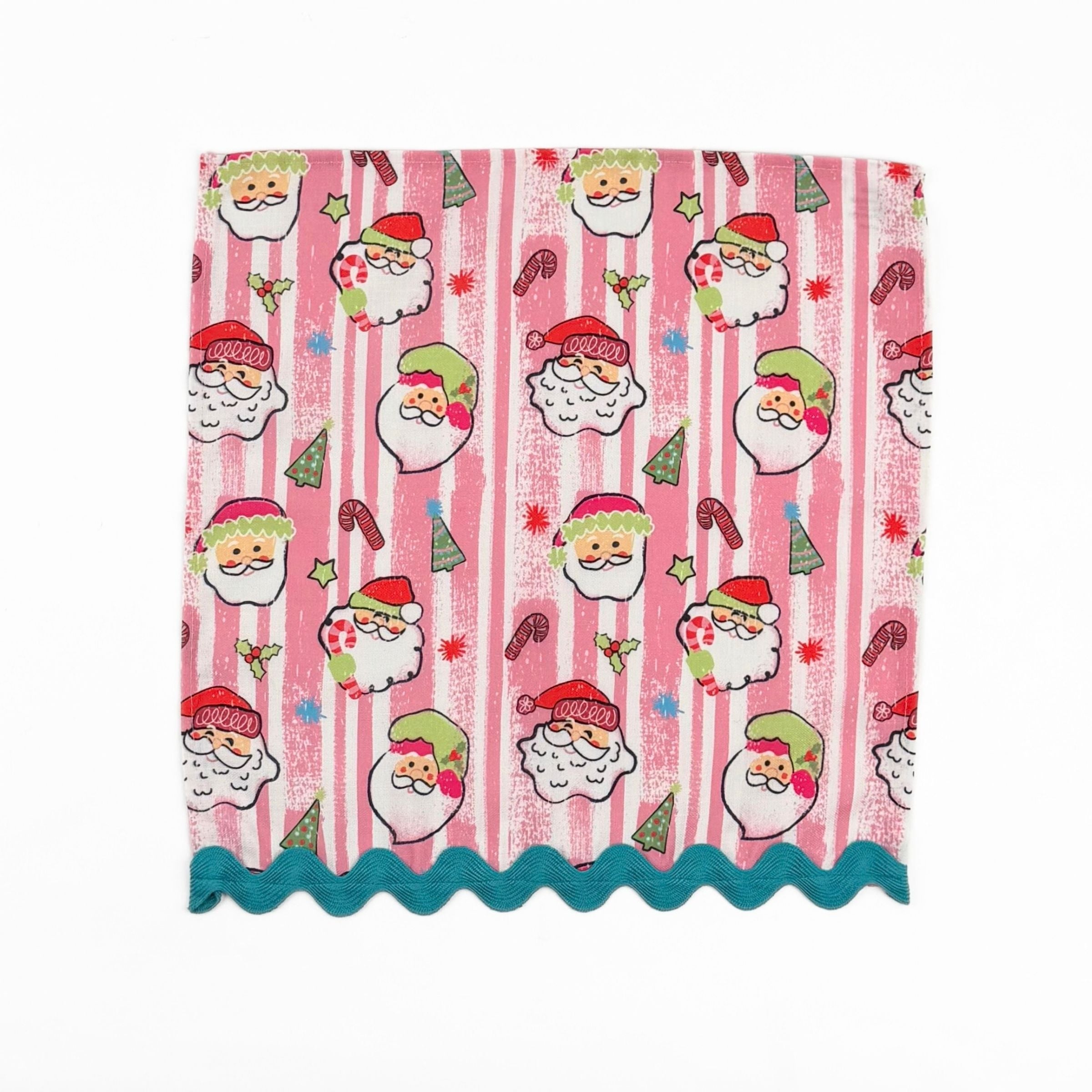 Pink striped Christmas dinner napkins featuring cheerful Santa faces, festive motifs, and turquoise ric rac trim.