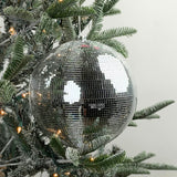 Large mirrored disco ball Christmas ornament featuring shimmering silver tiles, perfect for festive holiday decorating.